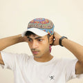 Model wearing a Coseta paisley scarf cap